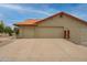 Large two car garage with a spacious driveway and clean, desert landscaping at 12899 W Pasadena Ave, Litchfield Park, AZ 85340