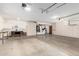 Spacious garage with ample cabinetry, work bench and overhead door openers at 12899 W Pasadena Ave, Litchfield Park, AZ 85340