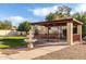 Gazebo and water feature set in a xeriscaped backyard with sidewalk at 12899 W Pasadena Ave, Litchfield Park, AZ 85340