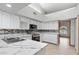 Stylish kitchen featuring white cabinets, modern countertops, and stainless steel appliances at 12899 W Pasadena Ave, Litchfield Park, AZ 85340