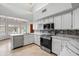 Bright kitchen with stainless steel appliances, white cabinets, and gorgeous countertops at 12899 W Pasadena Ave, Litchfield Park, AZ 85340
