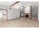 Inviting living room with brick fireplace, ceiling fan, and tile floors, ideal for entertaining at 12899 W Pasadena Ave, Litchfield Park, AZ 85340
