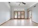 Bright and spacious living room with tile floors, doors to the patio and view of a hall at 12899 W Pasadena Ave, Litchfield Park, AZ 85340