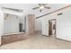Open-concept living space with tile flooring, brick fireplace, and exposed ceiling beams at 12899 W Pasadena Ave, Litchfield Park, AZ 85340