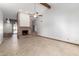 Spacious living room featuring a brick fireplace and tile flooring, perfect for Gathering gatherings at 12899 W Pasadena Ave, Litchfield Park, AZ 85340