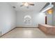 Spacious living room with tile flooring, ceiling fan, window, and unique brick feature at 12899 W Pasadena Ave, Litchfield Park, AZ 85340
