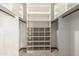 Organized walk-in closet features custom shelving with ample storage space for clothes and accessories at 12899 W Pasadena Ave, Litchfield Park, AZ 85340