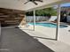 Covered patio leads to a pristine pool, perfect for outdoor relaxation and entertaining guests at 1423 W Joan De Arc Ave, Phoenix, AZ 85029