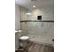 Bathroom featuring a new glass shower enclosure with marble tiling, plus updated fixtures at 1423 W Joan De Arc Ave, Phoenix, AZ 85029