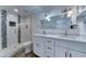 This bathroom features a dual sink vanity with a glass shower and black/white tile inlay at 1423 W Joan De Arc Ave, Phoenix, AZ 85029