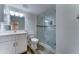 Bathroom featuring a shower with glass doors and modern fixtures at 1423 W Joan De Arc Ave, Phoenix, AZ 85029