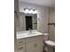 Bright bathroom featuring a new vanity with white cabinets and a marble countertop, with updated fixtures at 1423 W Joan De Arc Ave, Phoenix, AZ 85029