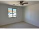 Bright bedroom with a ceiling fan and a large window offering ample natural light at 1423 W Joan De Arc Ave, Phoenix, AZ 85029