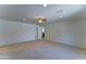 Large bedroom featuring neutral carpet, a ceiling fan, and easy access to an attached bathroom at 1423 W Joan De Arc Ave, Phoenix, AZ 85029