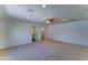 Generous bedroom with a ceiling fan, neutral carpet, and an attached bathroom for added privacy at 1423 W Joan De Arc Ave, Phoenix, AZ 85029