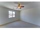 This bedroom features a ceiling fan and a window at 1423 W Joan De Arc Ave, Phoenix, AZ 85029