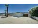 Spacious driveway leading to a two-car garage, complemented by desert landscaping and privacy walls at 1423 W Joan De Arc Ave, Phoenix, AZ 85029