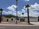 Charming single-story home featuring a two-car garage, palm trees, and desert landscaping at 1423 W Joan De Arc Ave, Phoenix, AZ 85029