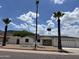 Charming single-story home featuring a two-car garage, palm trees, and desert landscaping at 1423 W Joan De Arc Ave, Phoenix, AZ 85029