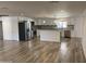 Open floor plan showcases kitchen with stainless steel appliances, and neutral paint at 1423 W Joan De Arc Ave, Phoenix, AZ 85029