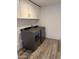 Laundry room with washer and dryer and new cabinets for storage at 1423 W Joan De Arc Ave, Phoenix, AZ 85029