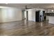 Bright and airy living room features wood-look flooring, access to the kitchen, and neutral paint at 1423 W Joan De Arc Ave, Phoenix, AZ 85029