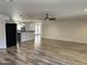 Open living space with ceiling fan and modern kitchen with island and stainless appliances at 1423 W Joan De Arc Ave, Phoenix, AZ 85029