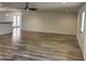 A spacious living room with wood-look flooring, ceiling fan, and neutral paint at 1423 W Joan De Arc Ave, Phoenix, AZ 85029