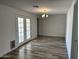 Bright living area featuring wood-look flooring, recessed lights, and a glass door leading to patio at 1423 W Joan De Arc Ave, Phoenix, AZ 85029