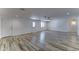Expansive living room with wood-look tile flooring, offering versatility for furniture arrangement and decor at 1423 W Joan De Arc Ave, Phoenix, AZ 85029