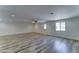 Large living area with wood-look tile, ample natural light, and a ceiling fan for added comfort at 1423 W Joan De Arc Ave, Phoenix, AZ 85029