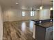 Spacious living room showcasing wood-look floors, modern lighting and abundant natural light at 1423 W Joan De Arc Ave, Phoenix, AZ 85029