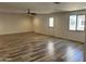 Large living room features wood-look flooring, ceiling fan, and access to the yard at 1423 W Joan De Arc Ave, Phoenix, AZ 85029