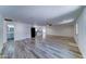 Spacious living room featuring wood-look tile flooring and neutral decor, ready for personalization at 1423 W Joan De Arc Ave, Phoenix, AZ 85029
