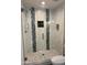New glass shower enclosure with marble tiling, plus updated fixtures and shampoo nook at 1423 W Joan De Arc Ave, Phoenix, AZ 85029
