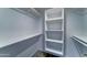 This walk-in closet features built-in shelving and custom storage system for maximum organization at 1423 W Joan De Arc Ave, Phoenix, AZ 85029