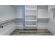 This walk-in closet has an open concept with several shelves and hanging spaces at 1423 W Joan De Arc Ave, Phoenix, AZ 85029