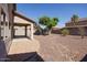 This home boasts a well-maintained backyard with desert landscaping and a covered patio area at 14552 W Hearn Rd, Surprise, AZ 85379