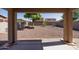 View of the spacious backyard with desert landscaping and covered patio, perfect for outdoor entertaining at 14552 W Hearn Rd, Surprise, AZ 85379