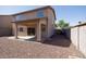 A backyard with desert landscaping, a patio, and access to the house at 14552 W Hearn Rd, Surprise, AZ 85379