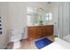 Well-maintained bathroom with double vanity, large mirror, and shower at 14552 W Hearn Rd, Surprise, AZ 85379