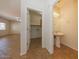 Bathroom with a pedestal sink and a doorway to a laundry room at 14552 W Hearn Rd, Surprise, AZ 85379