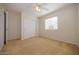 A neutral bedroom with carpet, a window, a ceiling fan, and a closet at 14552 W Hearn Rd, Surprise, AZ 85379