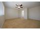 Large bedroom with a ceiling fan, neutral walls, and natural light coming from window at 14552 W Hearn Rd, Surprise, AZ 85379