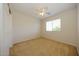 A neutral bedroom with carpet, a window, and a ceiling fan at 14552 W Hearn Rd, Surprise, AZ 85379