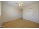 Neutral bedroom with a closet, carpet, and a ceiling fan at 14552 W Hearn Rd, Surprise, AZ 85379