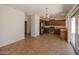 Open kitchen and living area with stainless steel appliances and sliding glass door to outside at 14552 W Hearn Rd, Surprise, AZ 85379