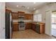The kitchen features stainless steel appliances, tan countertops, and ample storage at 14552 W Hearn Rd, Surprise, AZ 85379