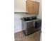 Well-equipped laundry area featuring front load washer and dryer set, tile flooring, and cabinetry for storage at 14552 W Hearn Rd, Surprise, AZ 85379