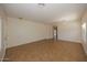 Bright living room features neutral walls, tile flooring, and ample natural light from large windows at 14552 W Hearn Rd, Surprise, AZ 85379